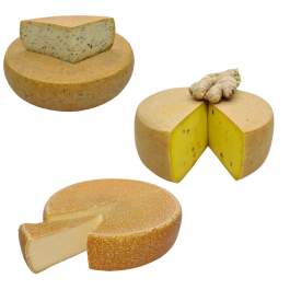 drei angeschnittene Käseräder, unterschiedliche Sorten Käse